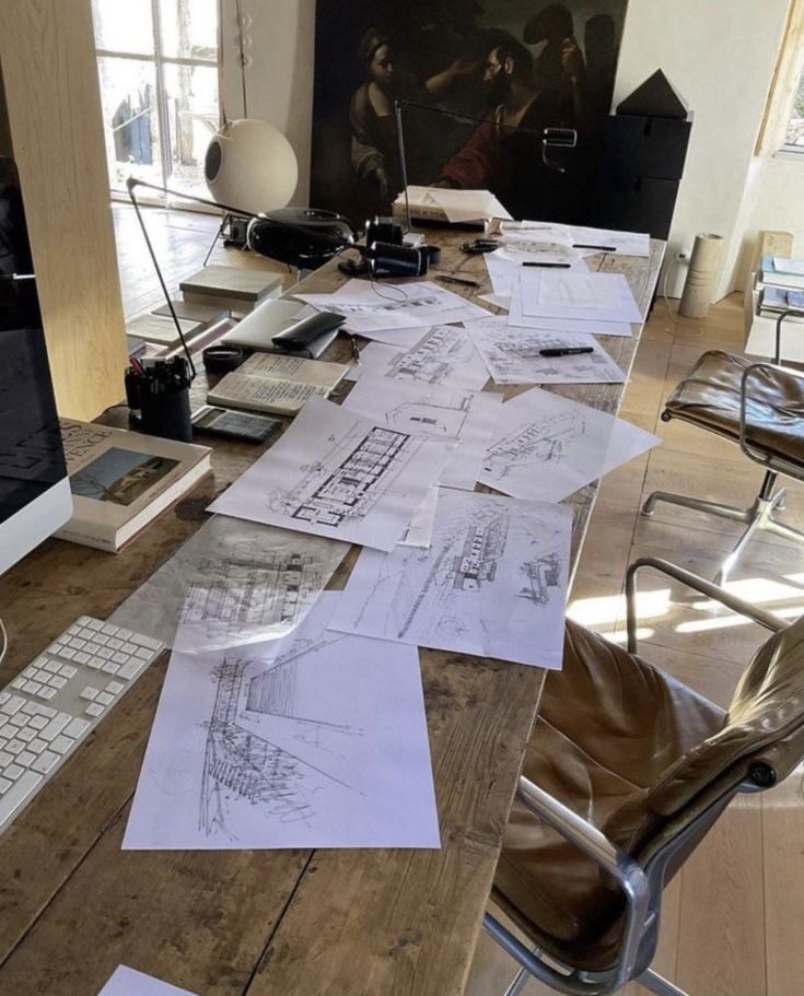 Hand-drawn plans on a studio desk